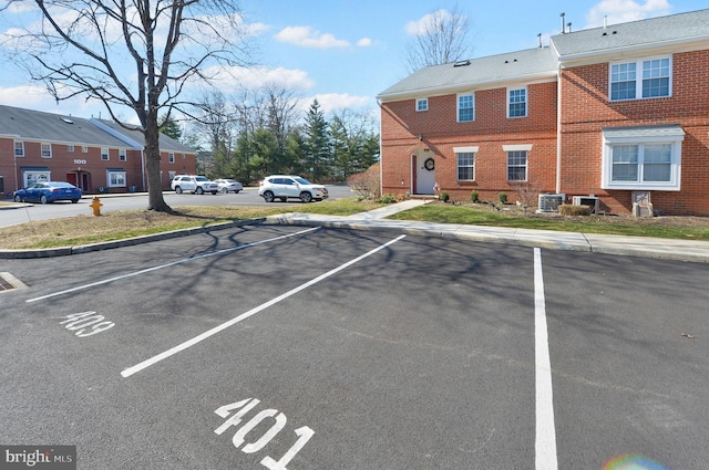 uncovered parking lot featuring a residential view