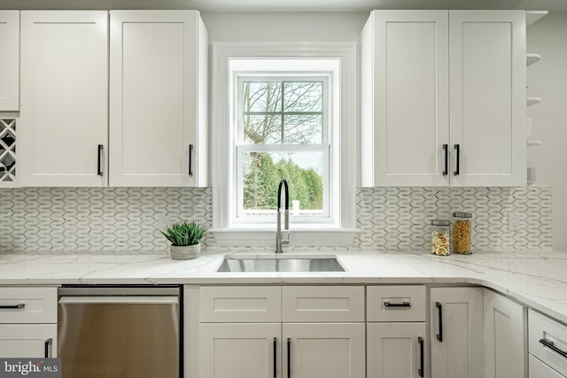 kitchen featuring a sink, dishwasher, and white cabinetry