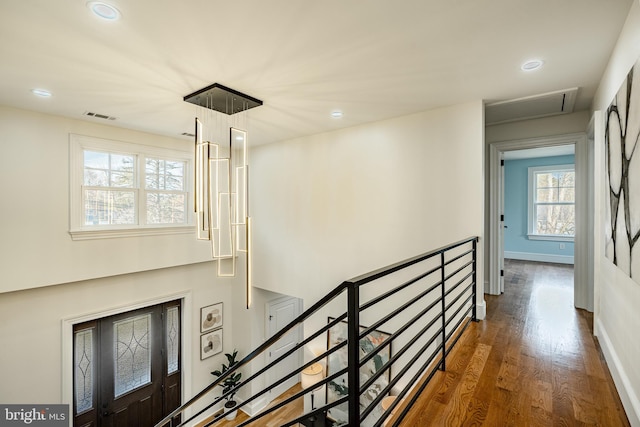 stairs featuring visible vents, recessed lighting, baseboards, and wood finished floors