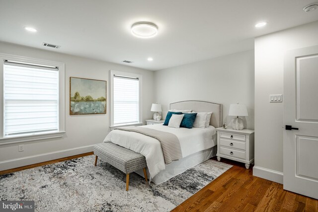 bedroom with visible vents, recessed lighting, baseboards, and wood finished floors