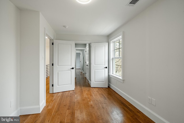 interior space featuring visible vents, baseboards, and light wood-style flooring