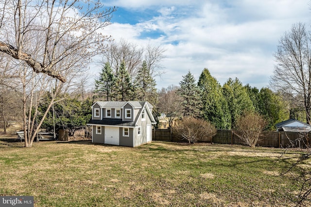 view of yard featuring an outdoor structure and fence private yard