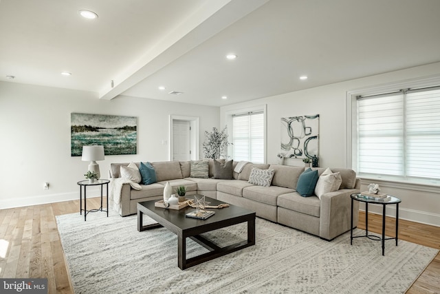living room with recessed lighting, baseboards, beam ceiling, and light wood-style floors