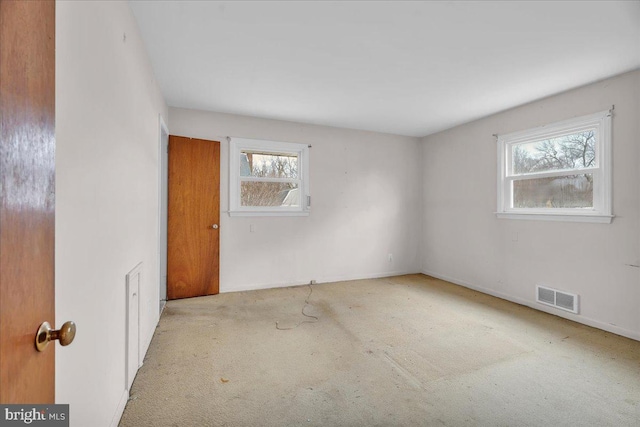 unfurnished room with visible vents