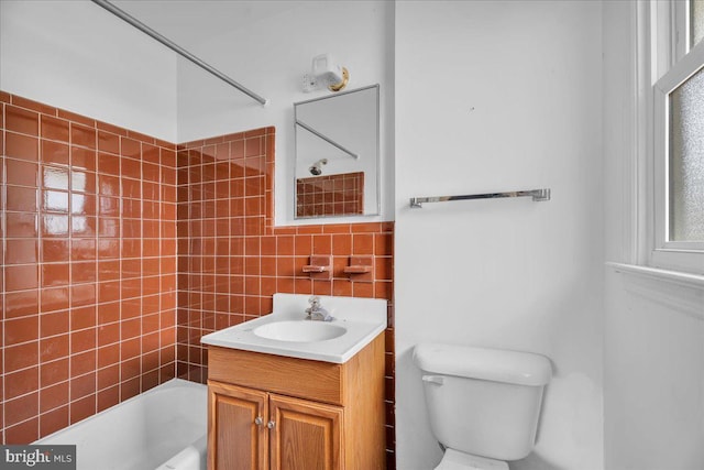 full bath with vanity, tub / shower combination, tile walls, toilet, and tasteful backsplash