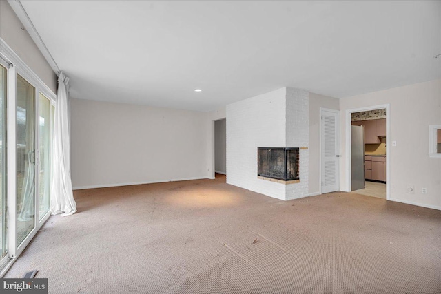 unfurnished living room with recessed lighting, a fireplace, baseboards, and carpet floors