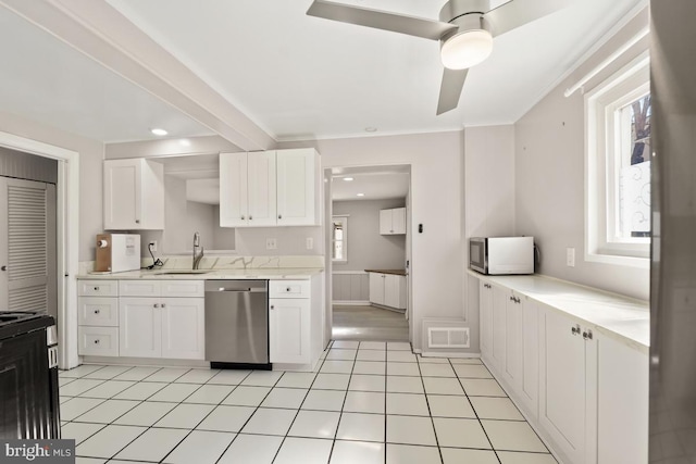 kitchen featuring visible vents, a healthy amount of sunlight, appliances with stainless steel finishes, white cabinets, and a sink