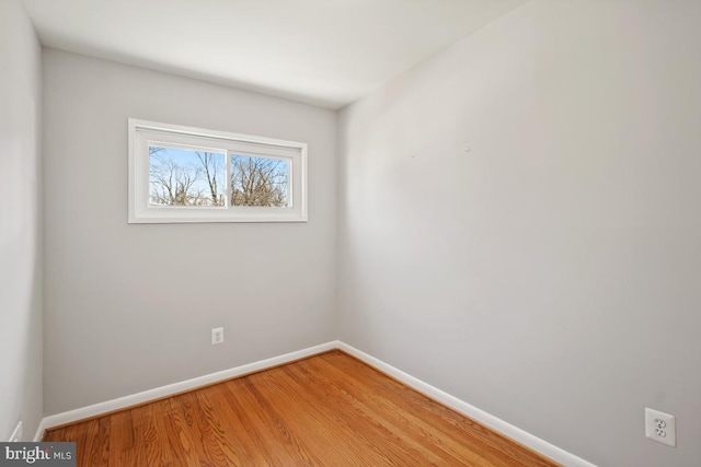 spare room with light wood finished floors and baseboards