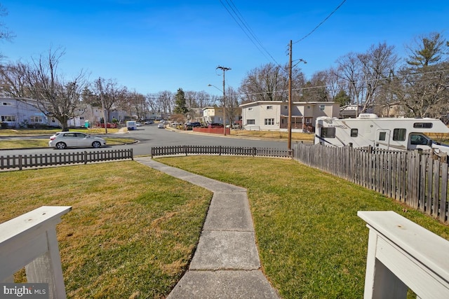 view of yard featuring a residential view and fence