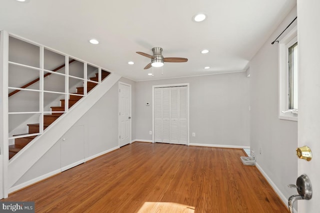 interior space with stairs, recessed lighting, wood finished floors, and baseboards