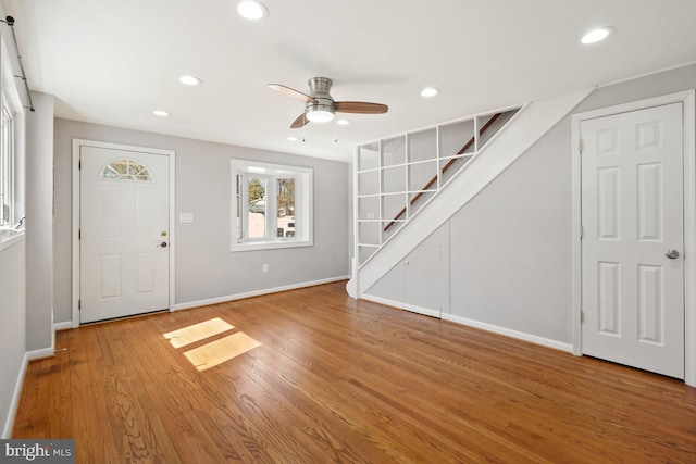 entryway with a ceiling fan, wood finished floors, recessed lighting, stairway, and baseboards