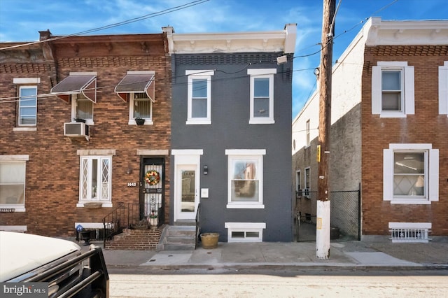 multi unit property featuring cooling unit and brick siding