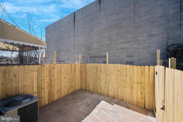 view of patio featuring fence and cooling unit