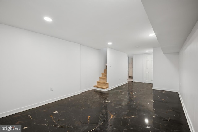 finished basement with baseboards, marble finish floor, recessed lighting, and stairway