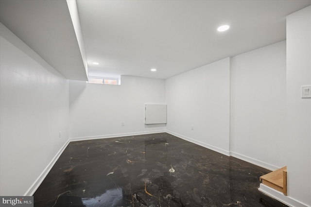 basement featuring baseboards and recessed lighting