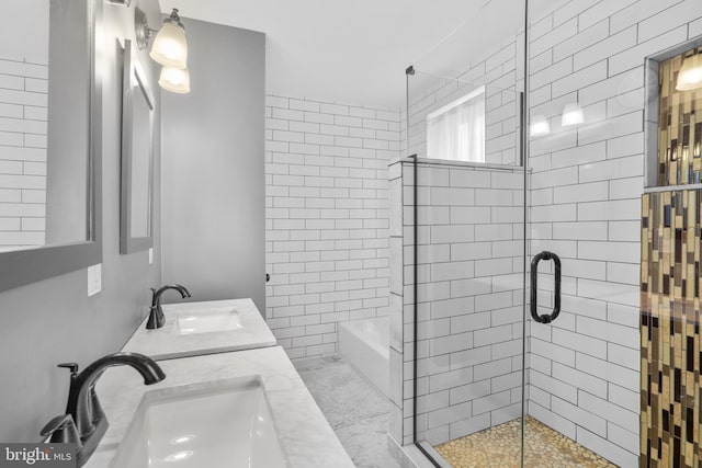 bathroom featuring a sink, tiled shower, a bathtub, and double vanity