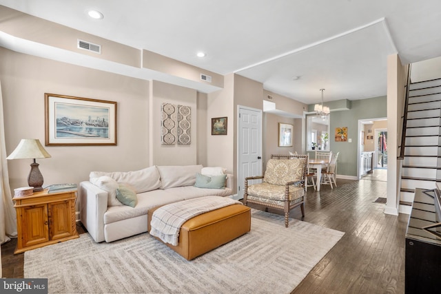 living area with visible vents, baseboards, recessed lighting, stairs, and wood-type flooring