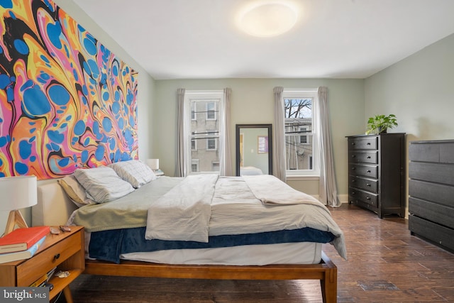 bedroom featuring baseboards and wood finished floors