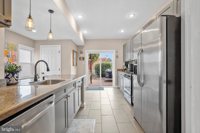 kitchen featuring a sink, decorative light fixtures, recessed lighting, appliances with stainless steel finishes, and light tile patterned floors