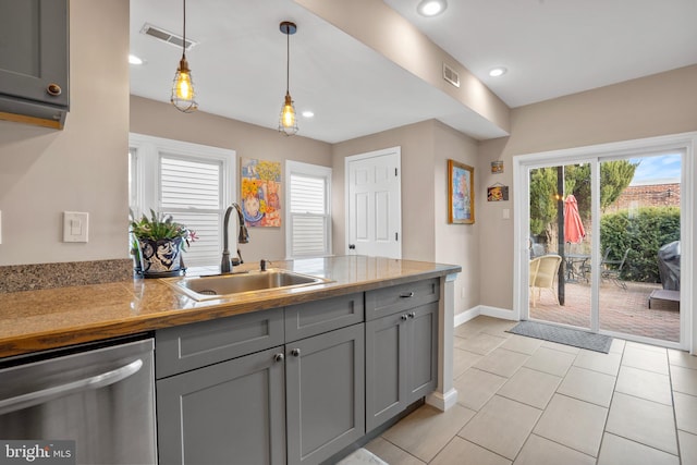 kitchen featuring gray cabinets, dishwasher, a peninsula, and a sink