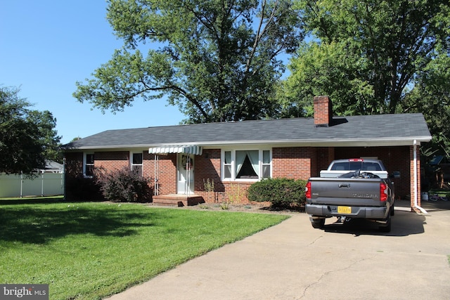 ranch-style home featuring concrete driveway, brick siding, and a front yard