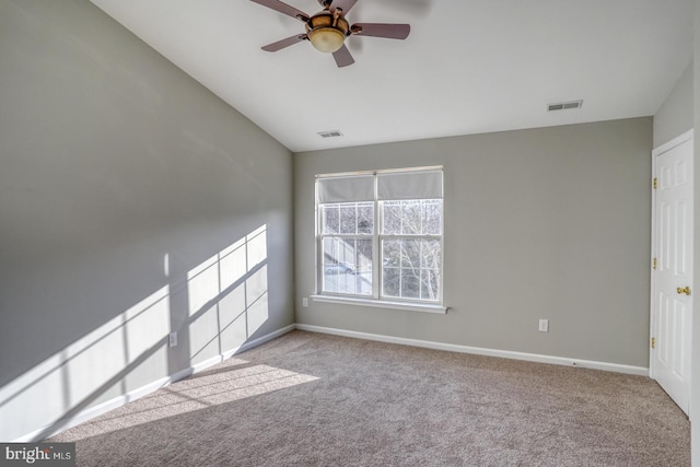 unfurnished room with visible vents, a ceiling fan, baseboards, and carpet floors