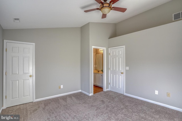 unfurnished bedroom featuring visible vents, ensuite bathroom, baseboards, and carpet floors