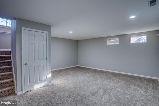 basement featuring visible vents, stairs, baseboards, and carpet floors