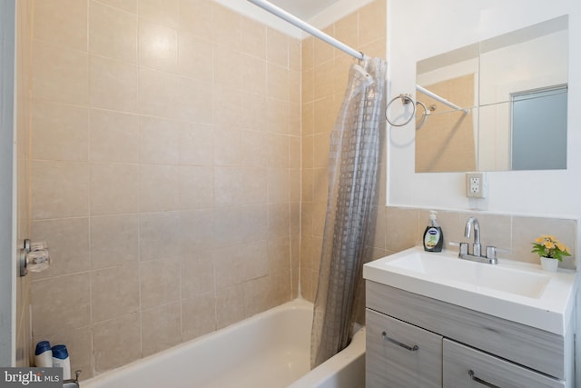 bathroom featuring decorative backsplash, vanity, tile walls, and shower / bath combo