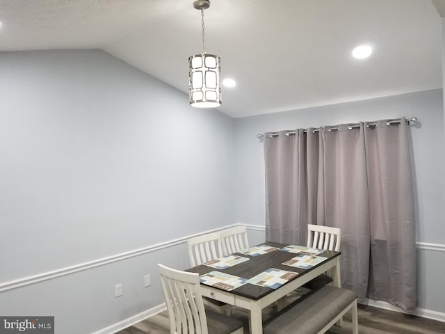 dining room with recessed lighting, dark wood-style flooring, and vaulted ceiling