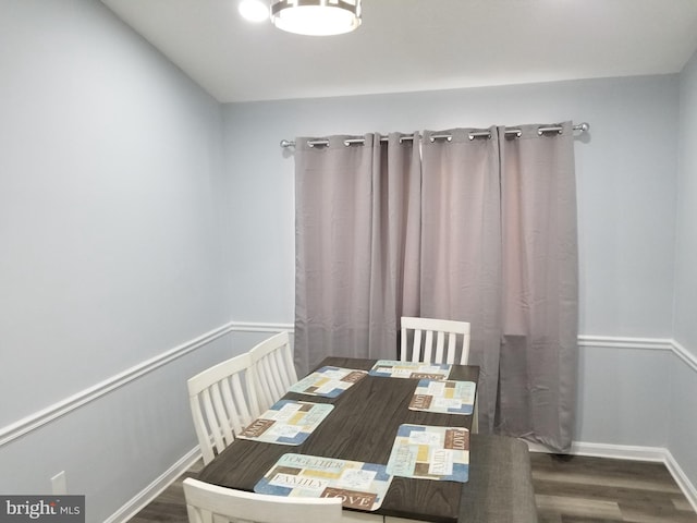 dining area featuring wood finished floors and baseboards