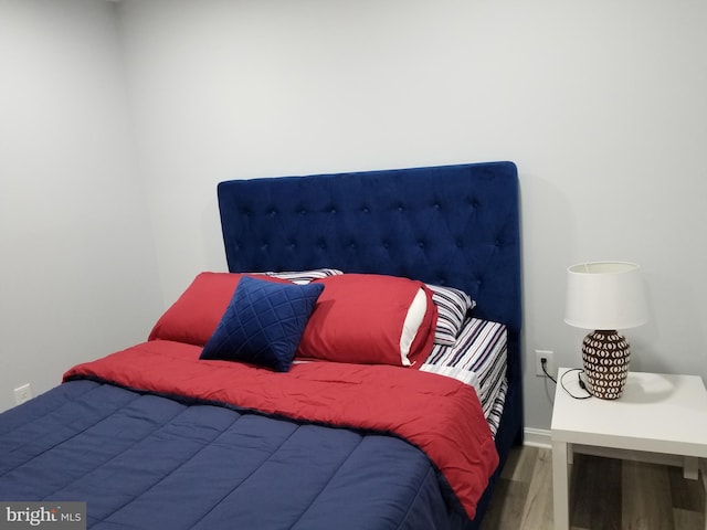 bedroom with wood finished floors and baseboards