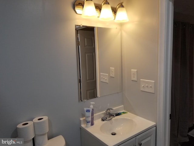 bathroom featuring toilet and vanity