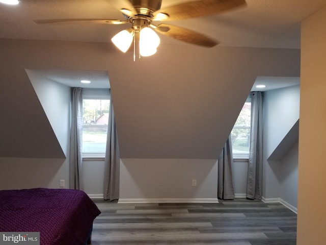 bedroom with a ceiling fan, wood finished floors, and baseboards