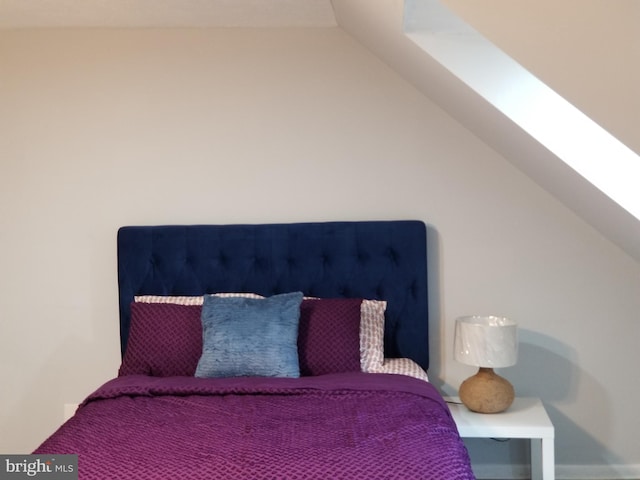 bedroom with lofted ceiling with skylight