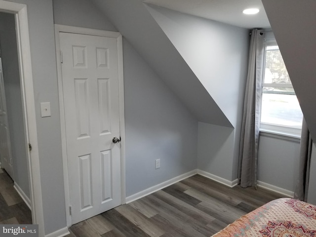 bonus room with vaulted ceiling, wood finished floors, and baseboards