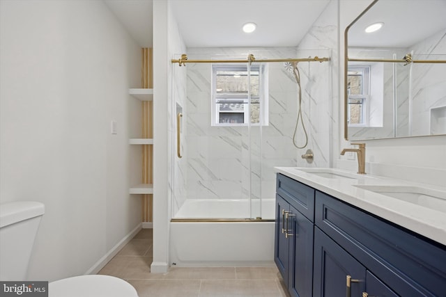 full bath featuring tile patterned flooring, double vanity, toilet, and a sink