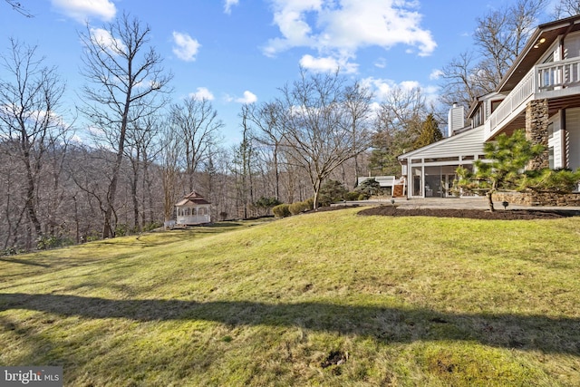 view of yard featuring a sunroom