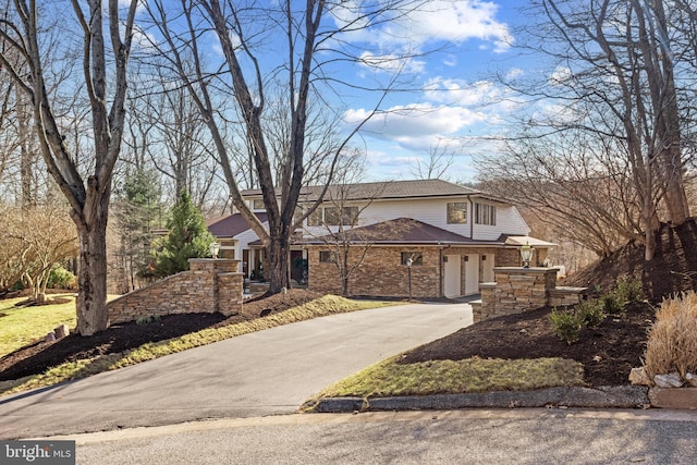 view of front of house with brick siding and driveway