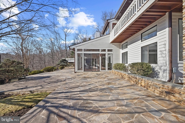 view of patio / terrace featuring a sunroom