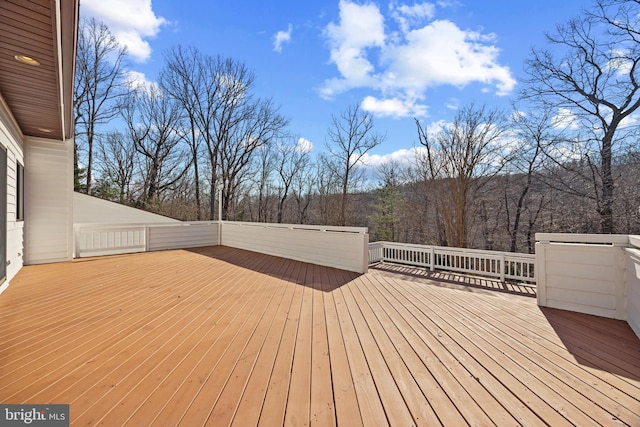 wooden deck with a view of trees