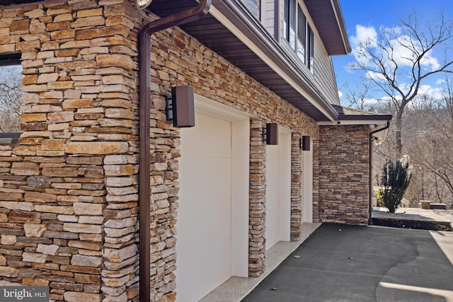 view of side of property with stone siding