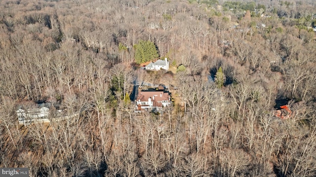 birds eye view of property with a forest view