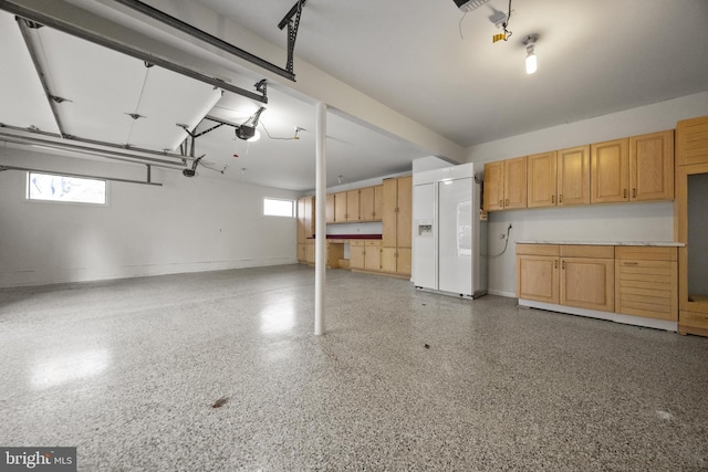 garage with a garage door opener and baseboards