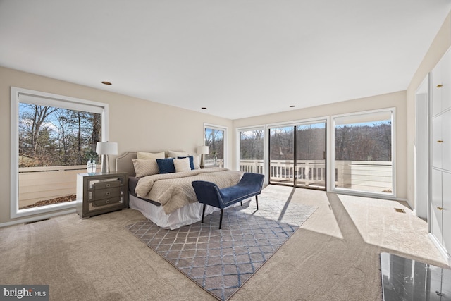 bedroom with access to exterior, carpet flooring, and visible vents