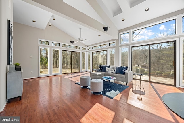 living room with recessed lighting, wood finished floors, baseboards, and high vaulted ceiling