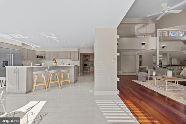 living room featuring recessed lighting, light wood finished floors, and ceiling fan