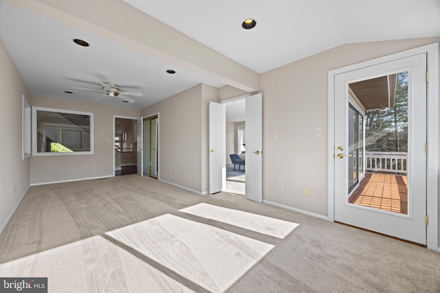 spare room with carpet flooring, a ceiling fan, lofted ceiling, and baseboards