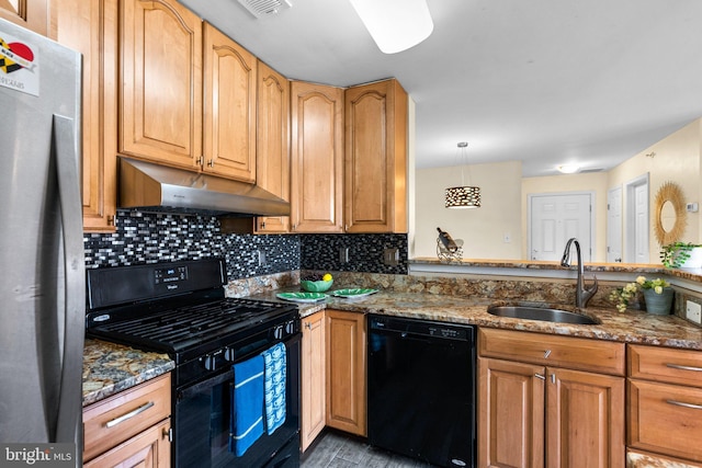 kitchen featuring under cabinet range hood, stone counters, black appliances, and a sink