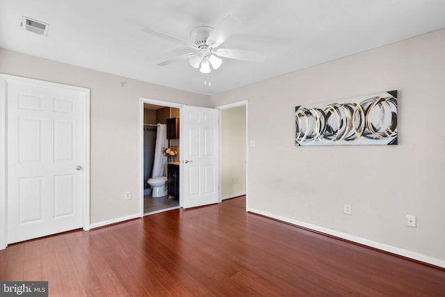 unfurnished bedroom with a ceiling fan, wood finished floors, visible vents, and baseboards